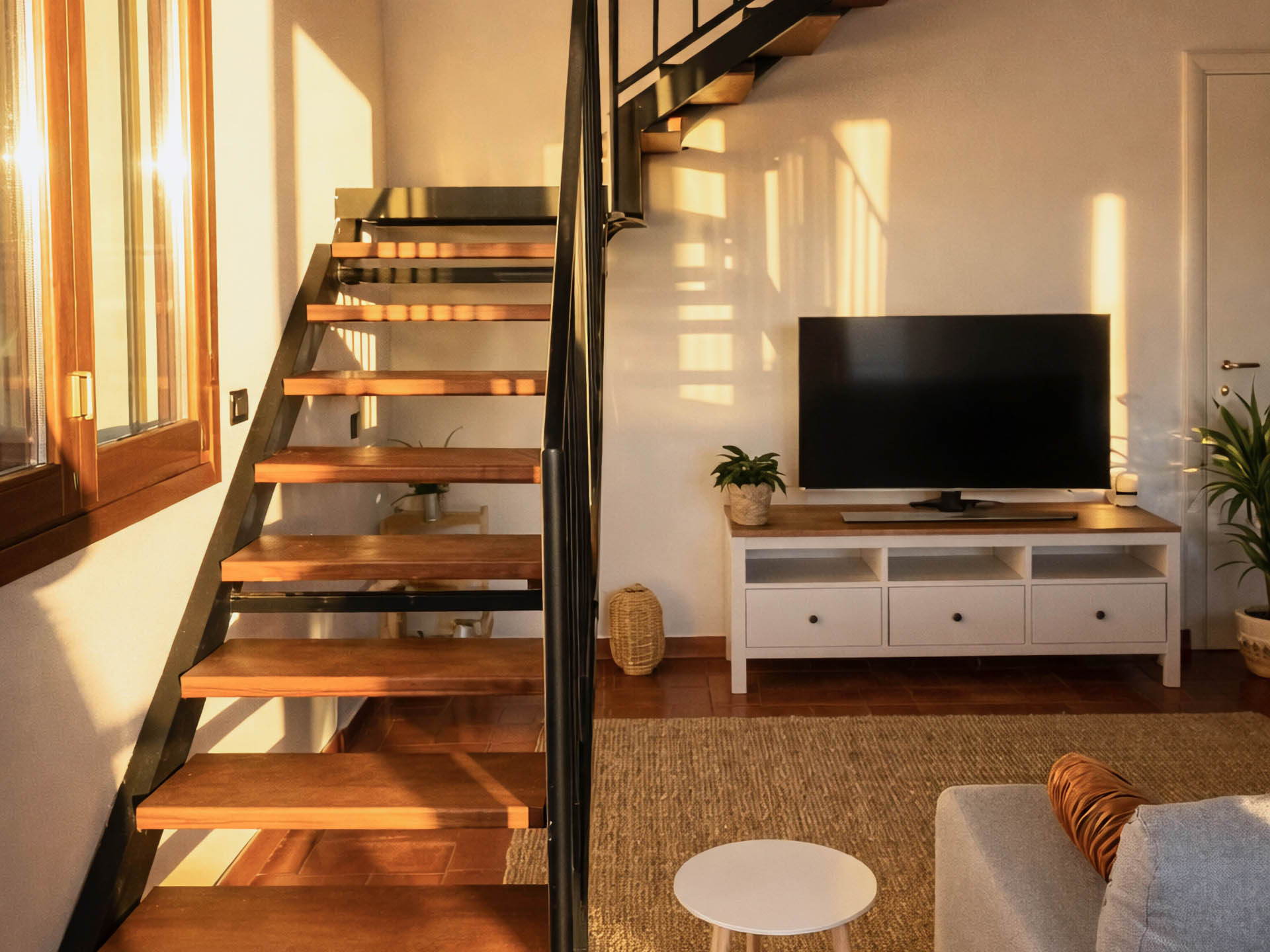 Living room with staircase leading to loft bedroom
